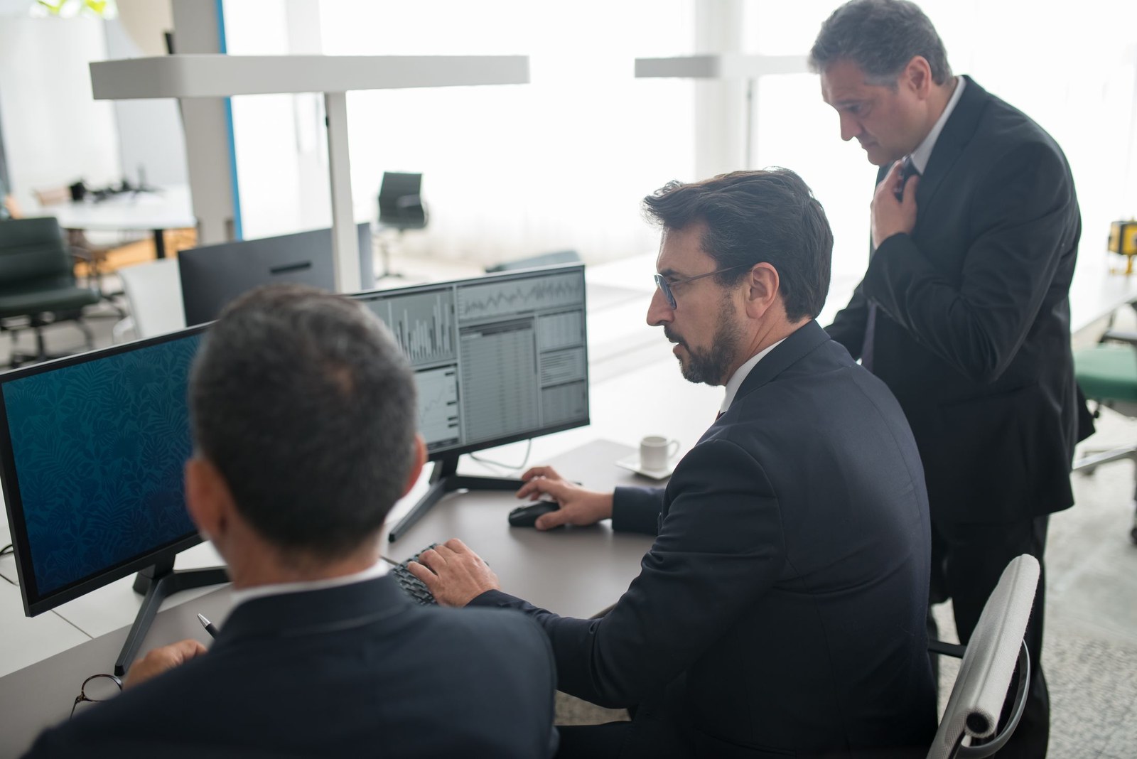 Operations specialists reviewing the day's routes on screen together