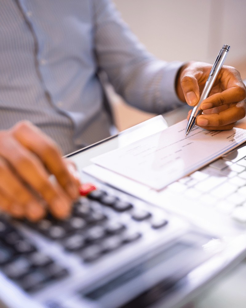 A weekly pay run being signed off beside a desk calculator
