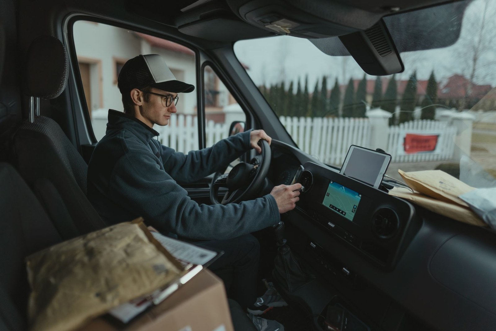 A delivery driver at the wheel with the in-cab navigation unit running